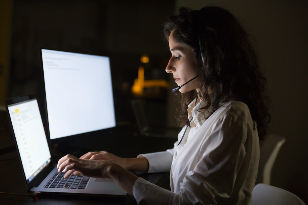focused-businesswoman-headset-using-laptop
